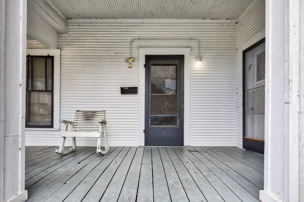a view of a house with wooden deck