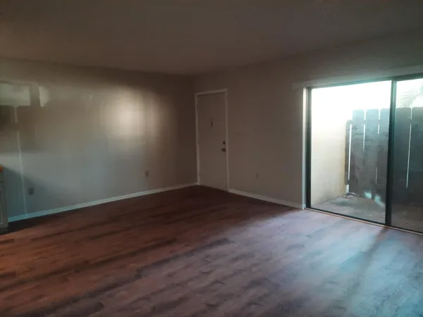 a kitchen with a sink cabinets and wooden floor