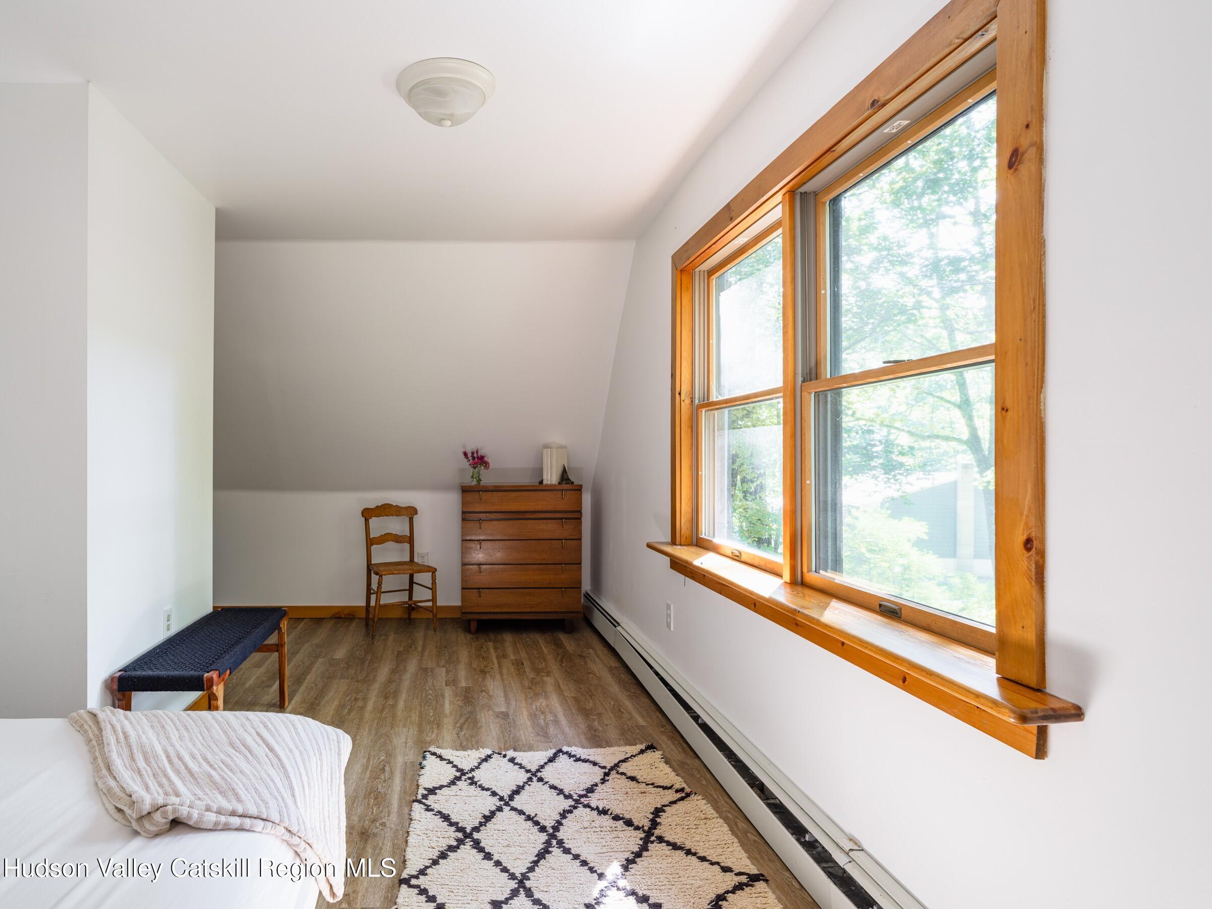 106 Tick Tock Way Stanfordville, NY 12581 - Photo 13 of 22 a view of a bedroom with furniture and a window