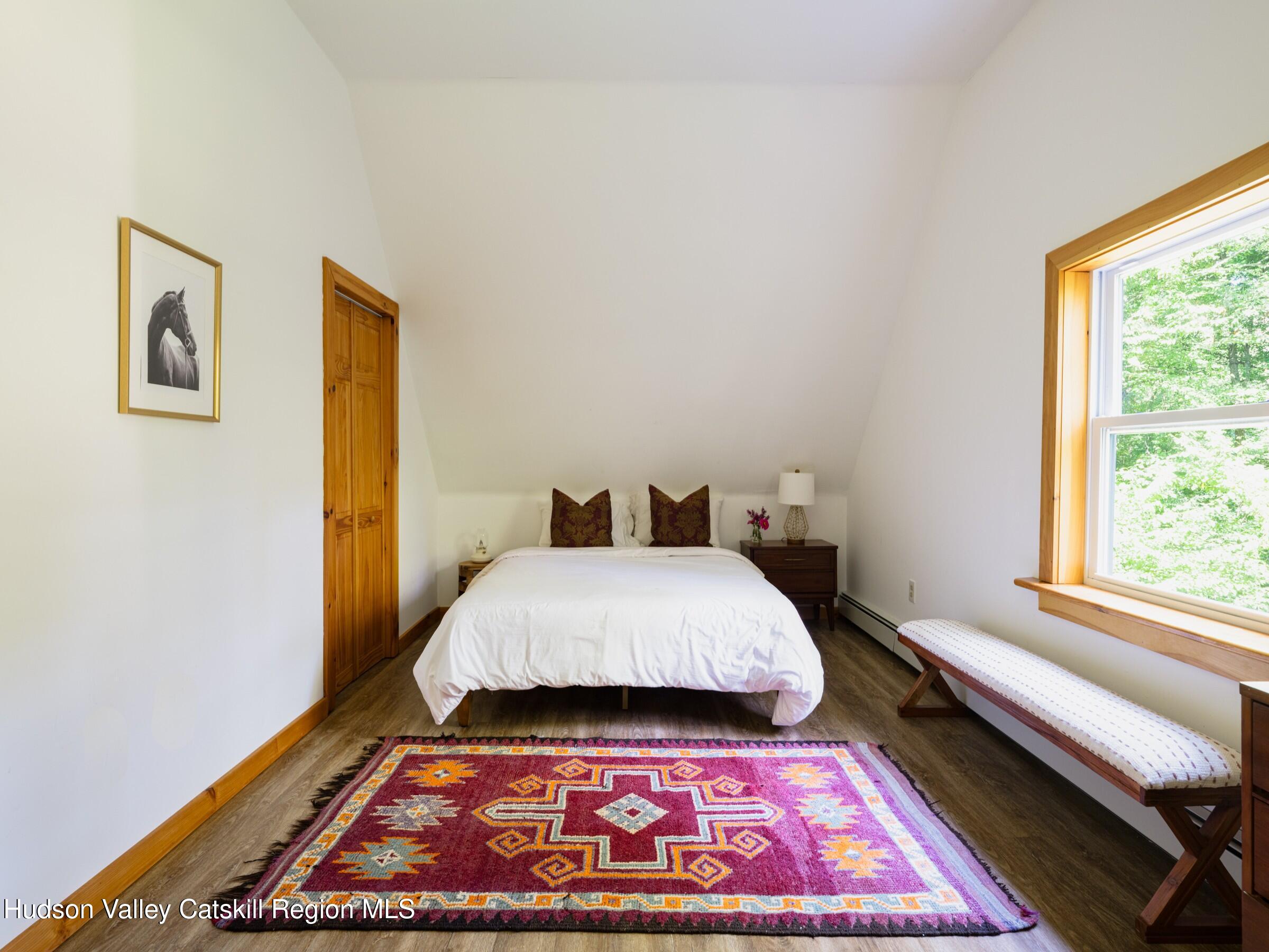 106 Tick Tock Way Stanfordville, NY 12581 - Photo 16 of 22 a bed sitting in a bedroom next to a window