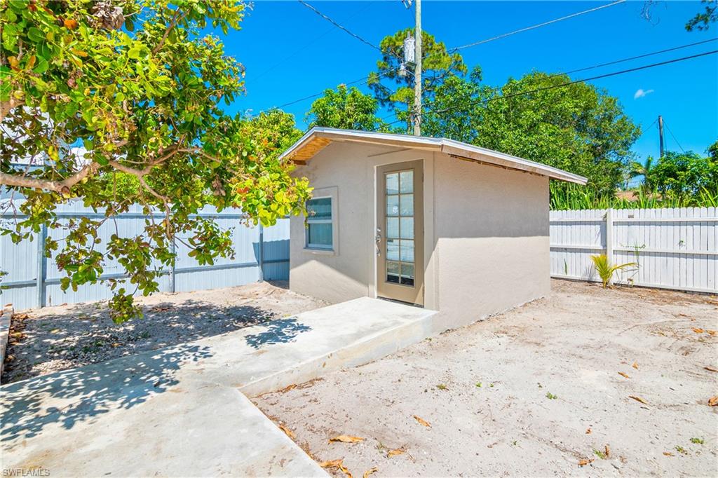 5350 Catts Street Naples, FL 34113 - Photo 20 of 21 a view of a house with a yard and potted plants
