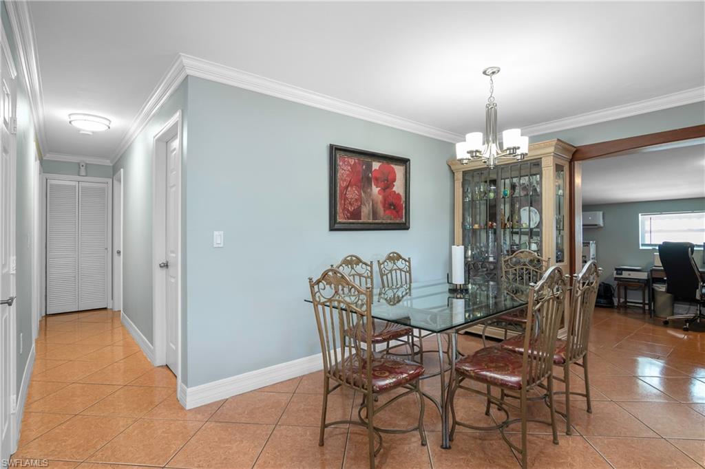 5350 Catts Street Naples, FL 34113 - Photo 7 of 21 a view of a dining room with furniture and chandelier