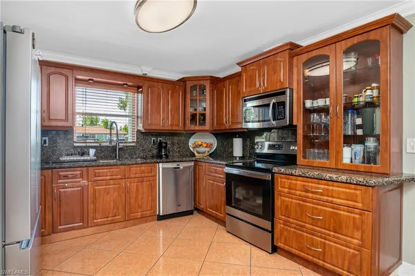 a kitchen with stainless steel appliances granite countertop a stove and cabinets