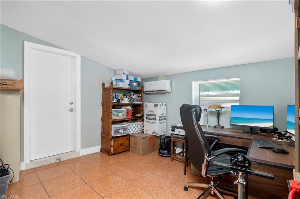 5350 Catts Street Naples, FL 34113 - Photo 10 of 21 a view of a workspace with furniture and a window