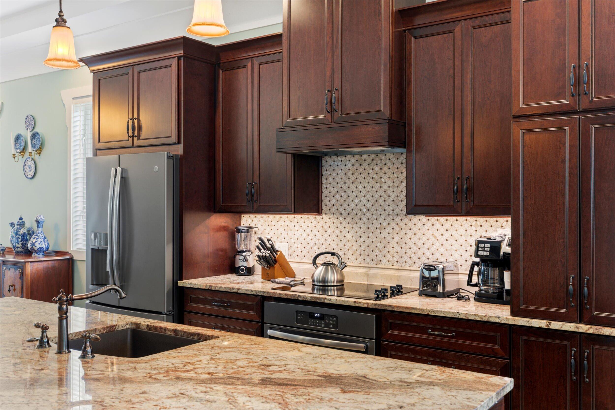 512 Amelia Street Key West, FL 33040 - Photo 23 of 52 a kitchen with wooden cabinets and a sink