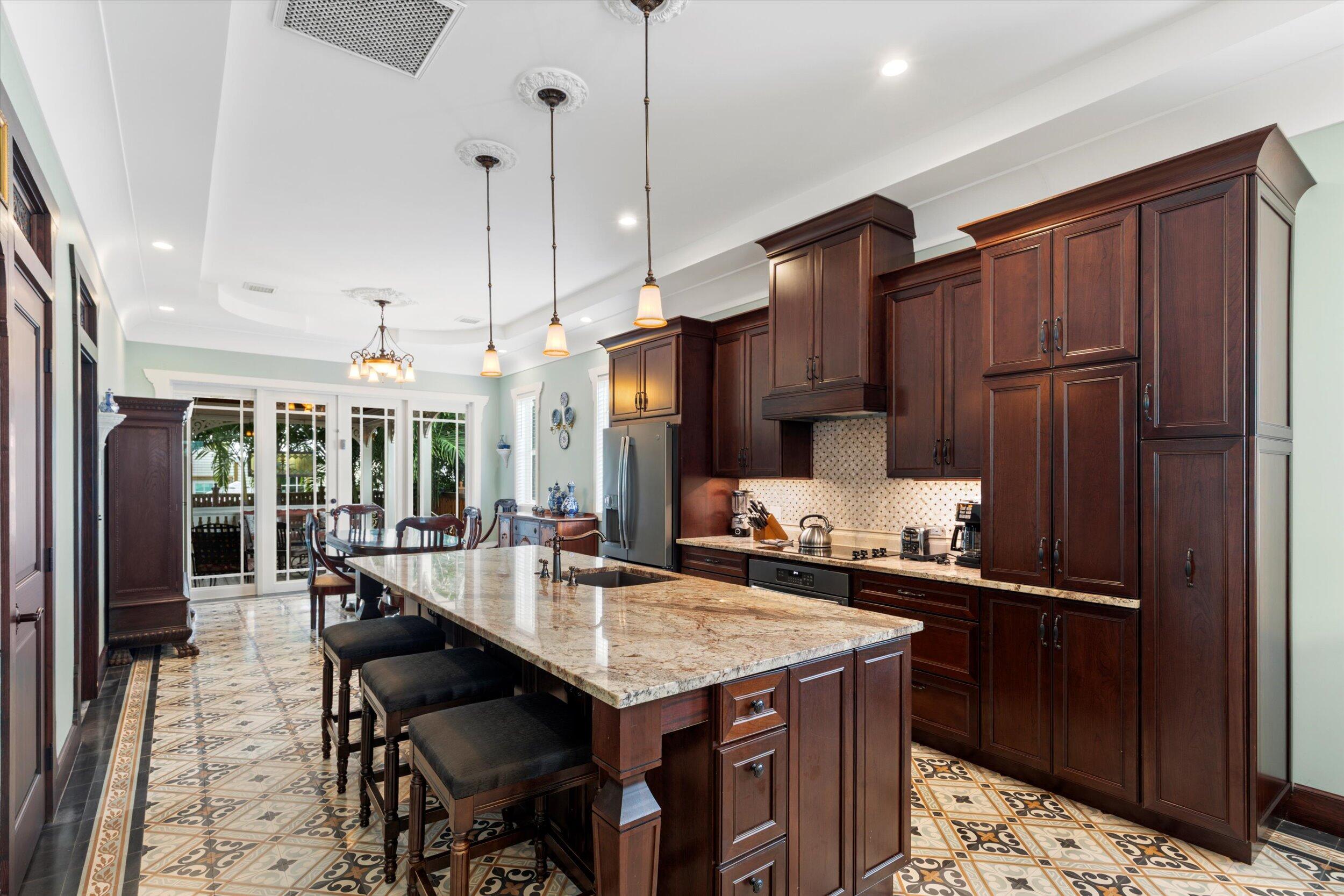 512 Amelia Street Key West, FL 33040 - Photo 24 of 52 a kitchen with a table chairs and refrigerator