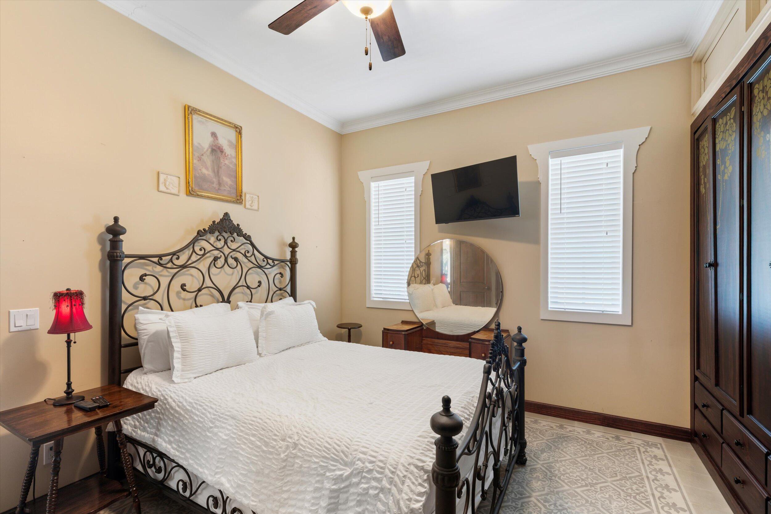 512 Amelia Street Key West, FL 33040 - Photo 30 of 52 a bedroom with a bed and a chair