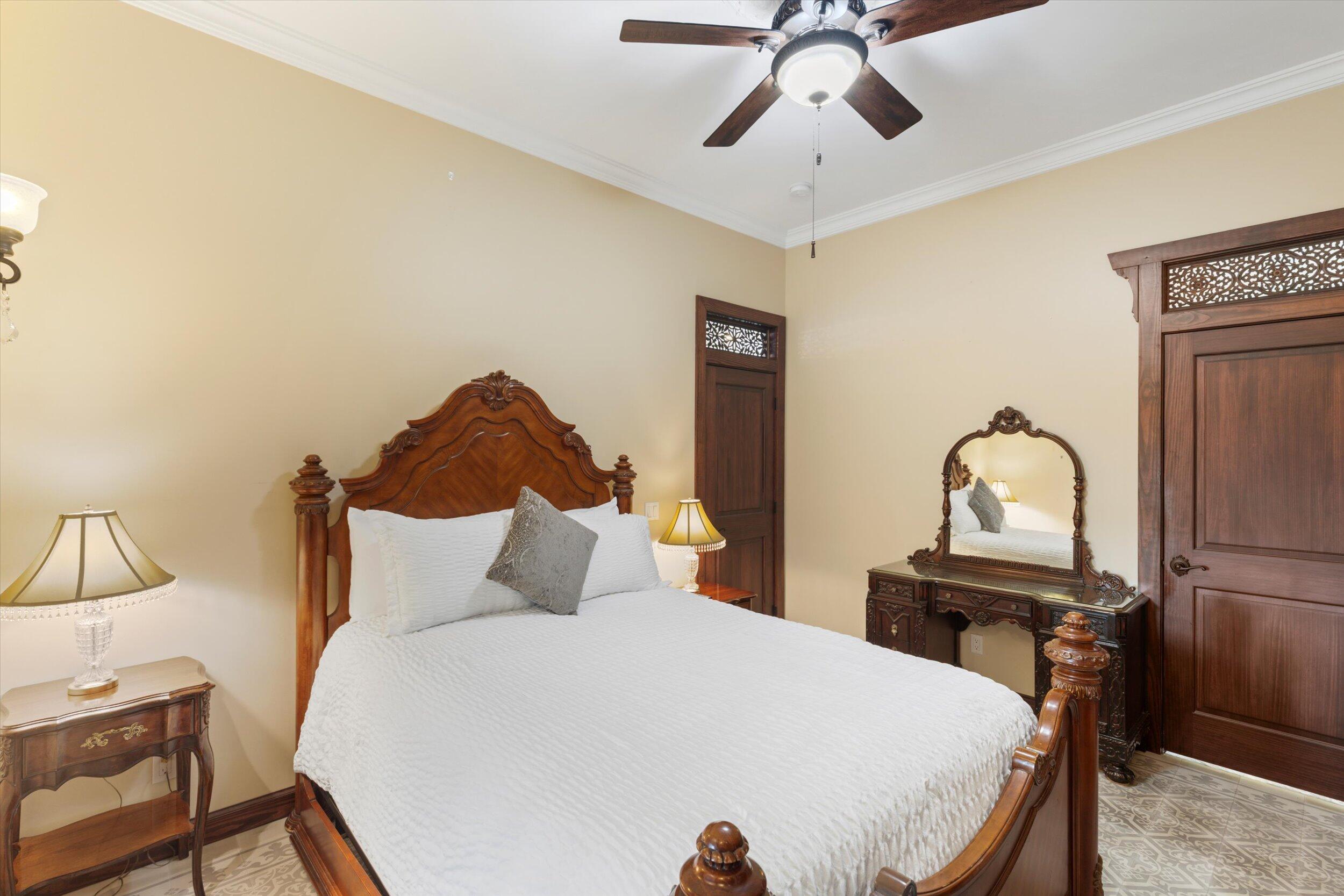512 Amelia Street Key West, FL 33040 - Photo 39 of 52 a bedroom with a bed and a chandelier