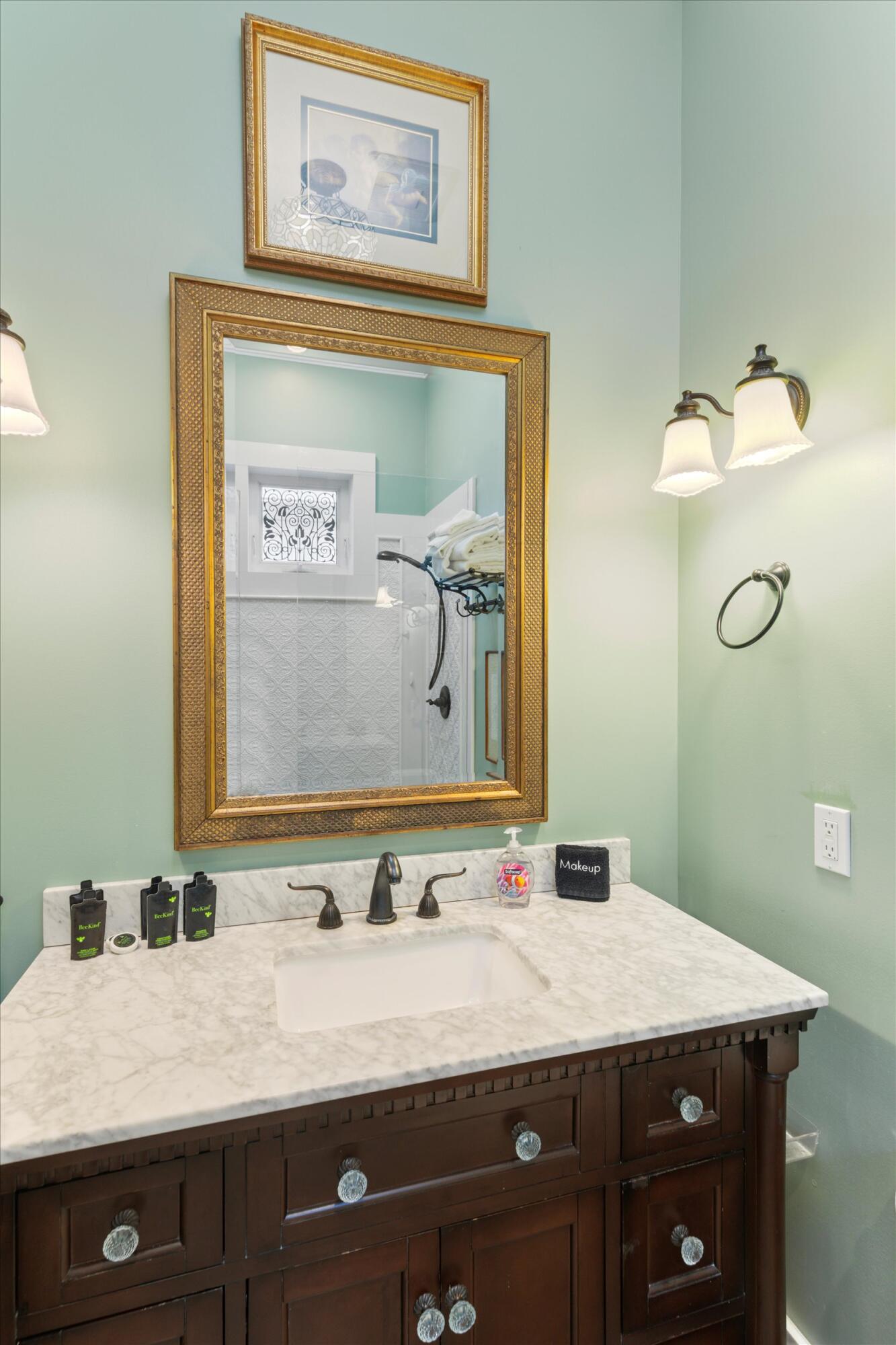 512 Amelia Street Key West, FL 33040 - Photo 42 of 52 a bathroom with a granite countertop sink and a mirror