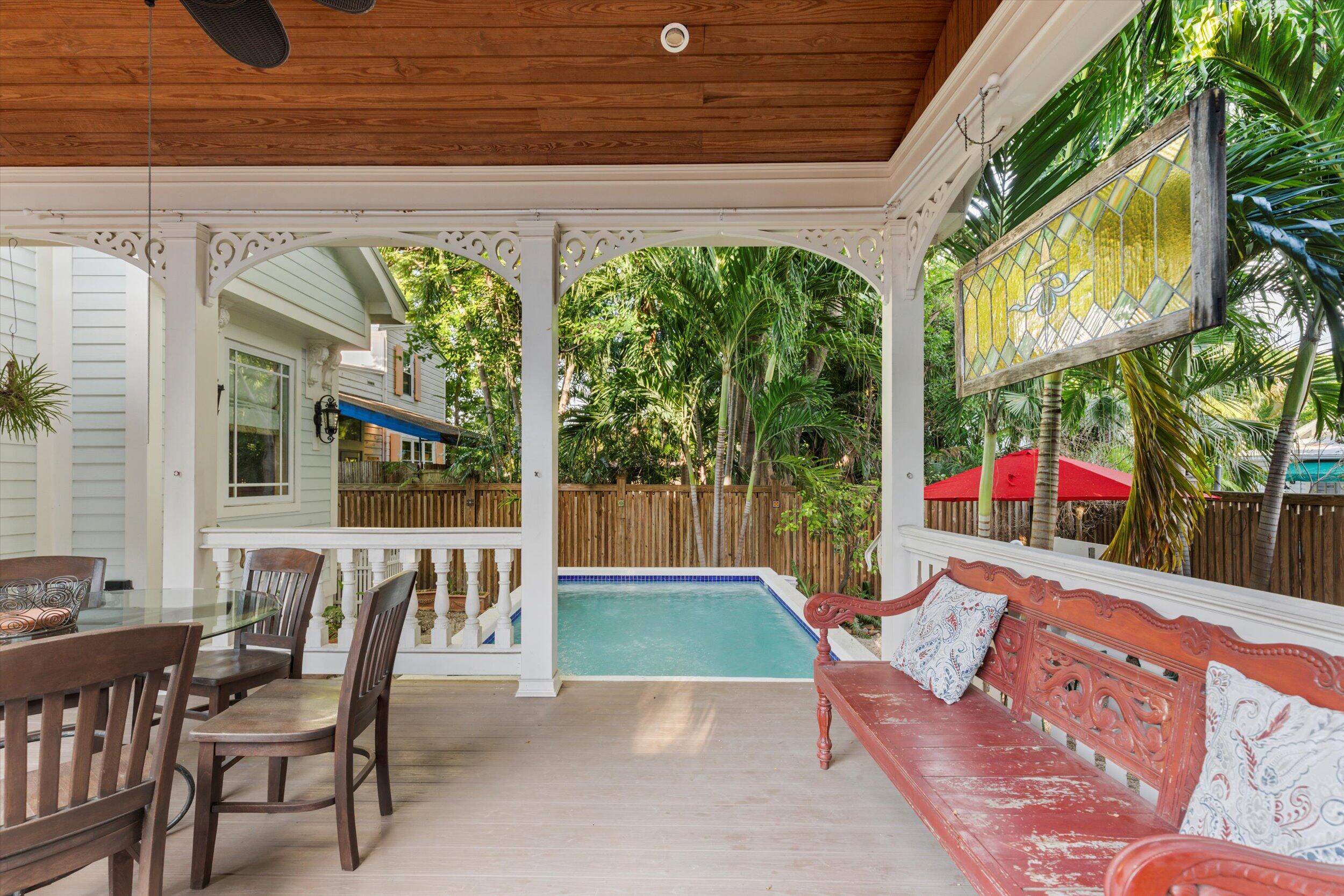 512 Amelia Street Key West, FL 33040 - Photo 46 of 52 a view of an outdoor dining space with a table and chairs
