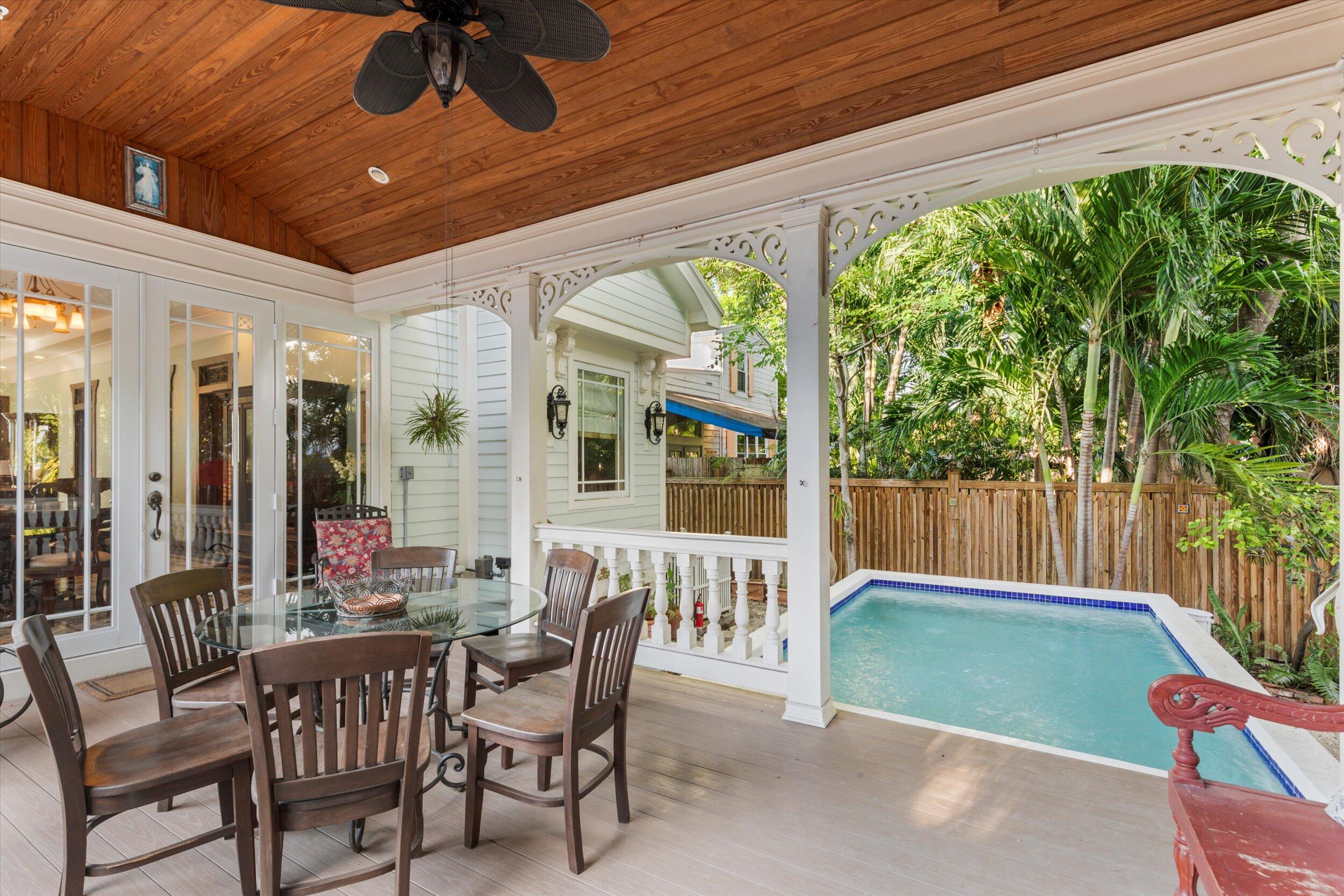512 Amelia Street Key West, FL 33040 - Photo 47 of 52 a patio with yard glass top table and chairs