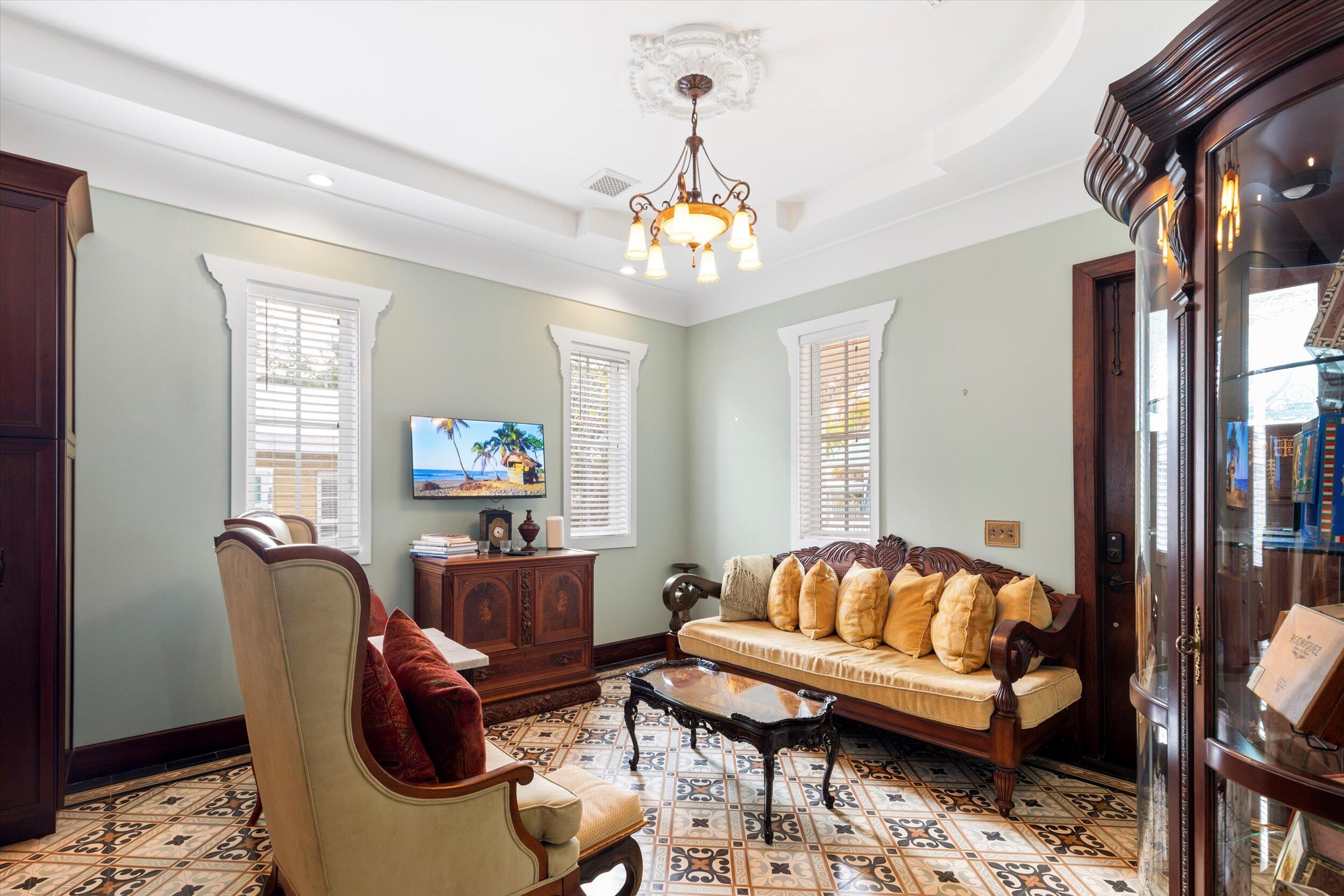 512 Amelia Street Key West, FL 33040 - Photo 9 of 52 a living room with furniture a dining table and a chandelier