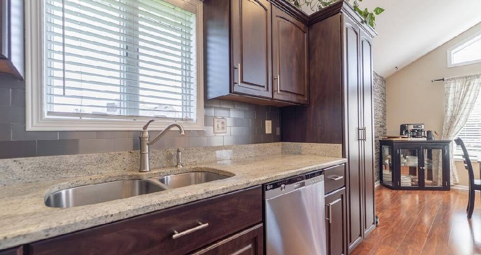 9166 Maple Court St. John, IN 46373 - Photo 14 of 40 a kitchen with stainless steel appliances granite countertop a sink and a wooden cabinets