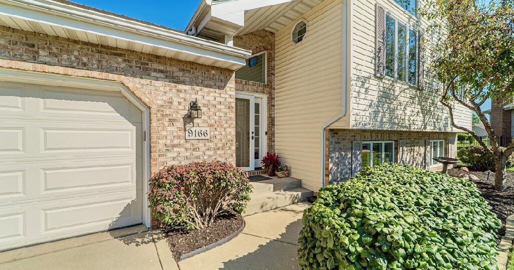 9166 Maple Court St. John, IN 46373 - Photo 2 of 40 a view of a front door and a potted plant