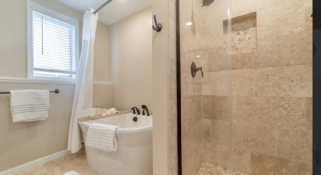 9166 Maple Court St. John, IN 46373 - Photo 26 of 40 a bathroom with a bathtub and shower