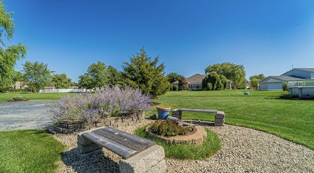 9166 Maple Court St. John, IN 46373 - Photo 34 of 40 a view of backyard with outdoor seating and green space