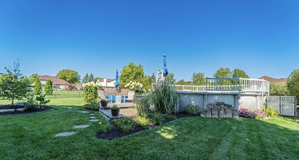 9166 Maple Court St. John, IN 46373 - Photo 39 of 40 a view of a house with a backyard and a garden