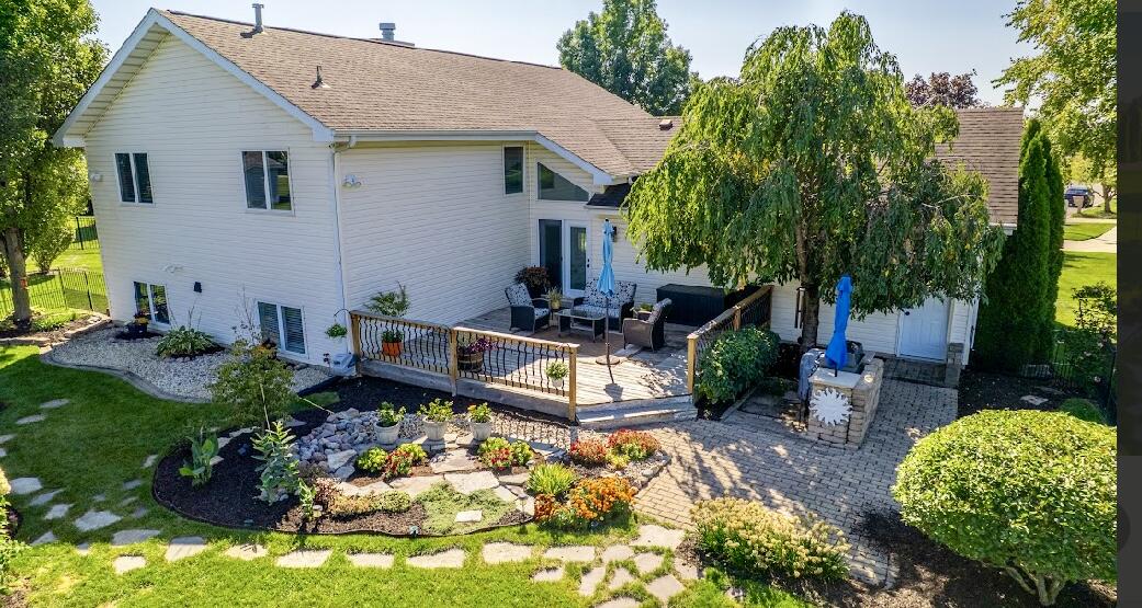 9166 Maple Court St. John, IN 46373 - Photo 5 of 40 a view of a backyard with plants and a patio