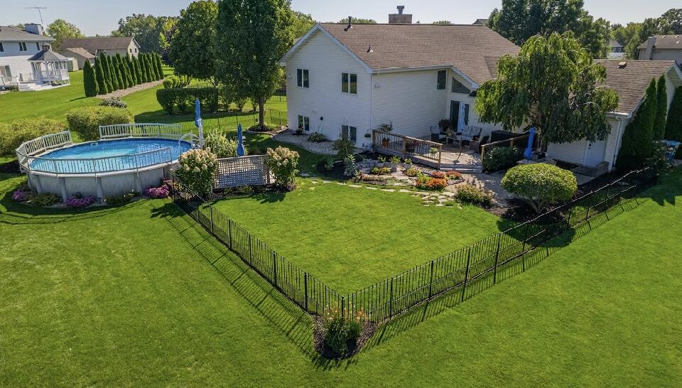9166 Maple Court St. John, IN 46373 - Photo 6 of 40 a view of an house with backyard space and swimming pool