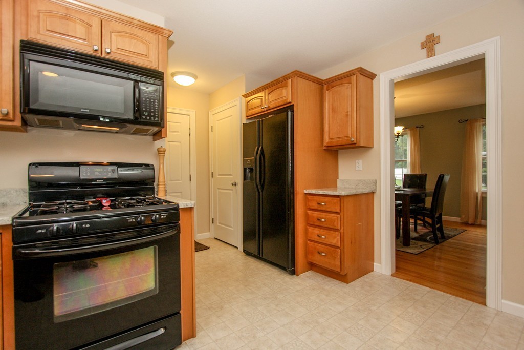 49 Chester Street West Springfield, MA 01089 - Photo 13 of 25 a kitchen with a stove and a microwave