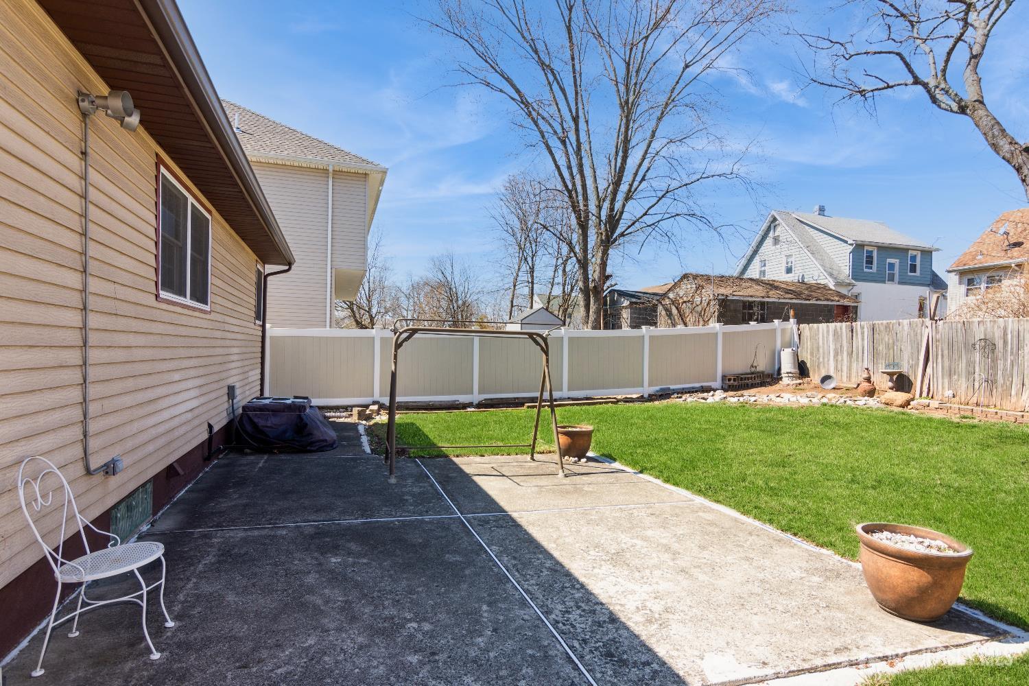 157 Orange Street Edison, NJ 08817 - Photo 18 of 19 a view of a patio with a table and chairs and a barbeque