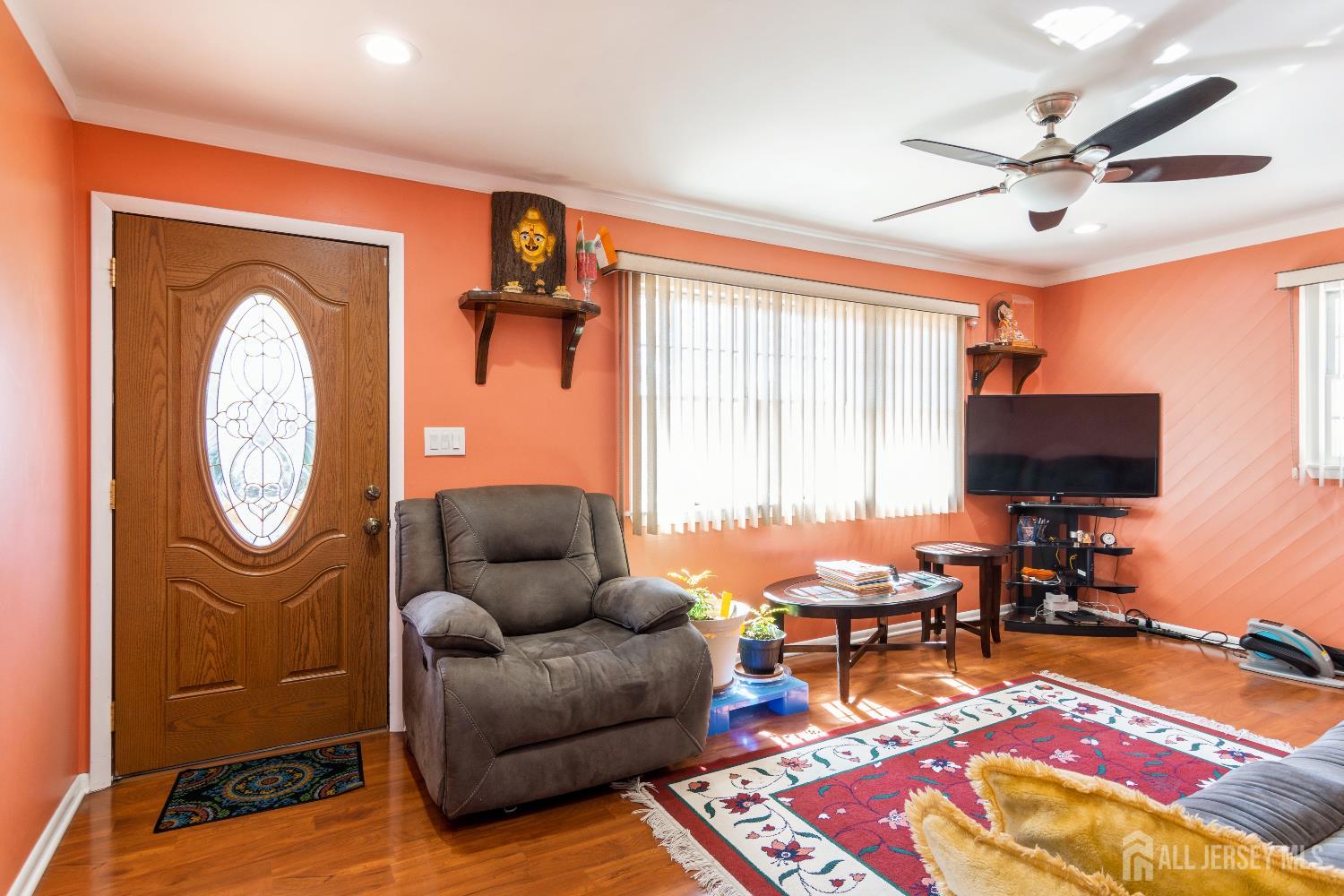 157 Orange Street Edison, NJ 08817 - Photo 4 of 19 a living room with furniture and a flat screen tv