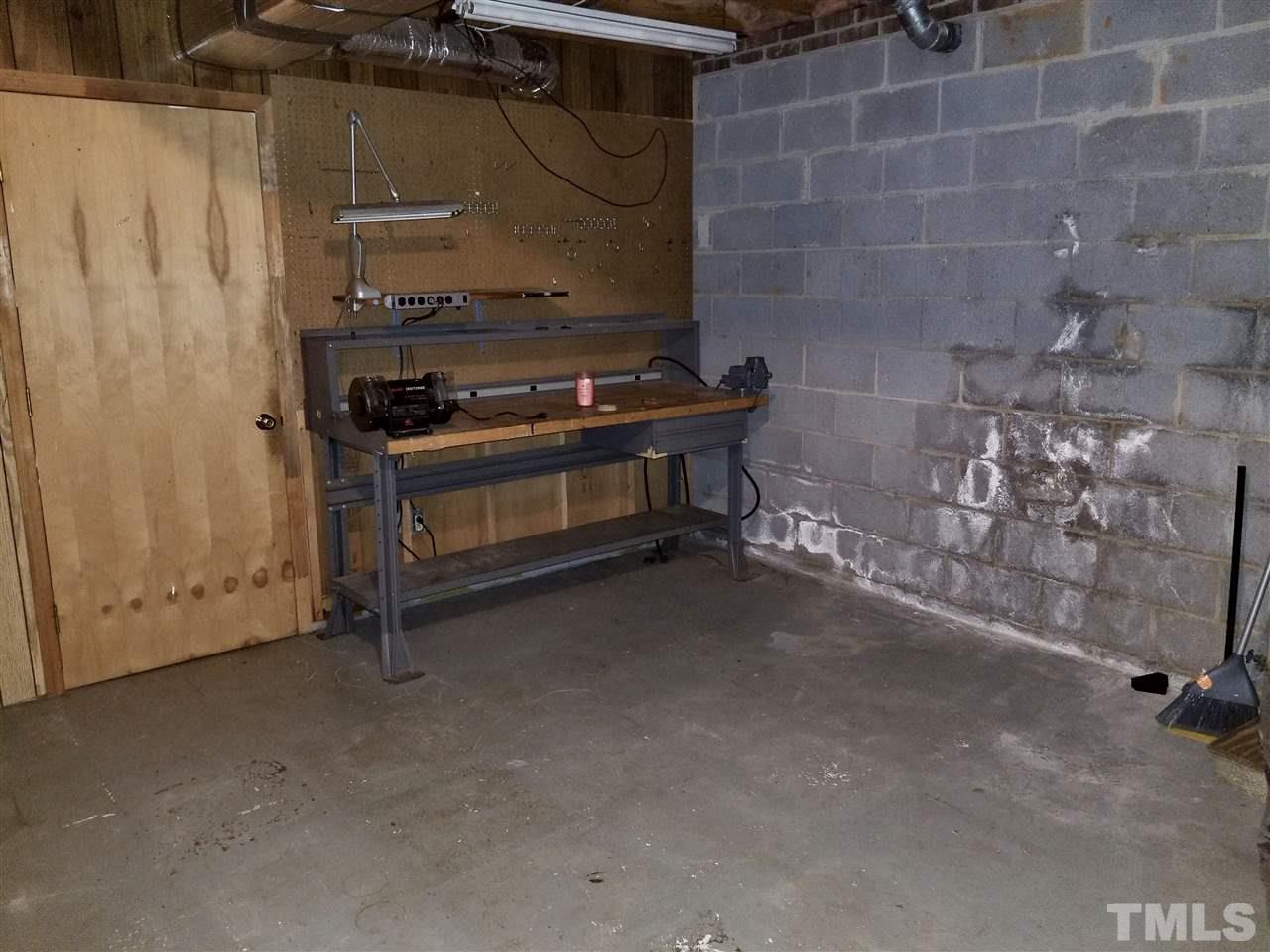 6420 Rockrest Court Raleigh, NC 27612 - Photo 18 of 22 Workshop area in the unfinished portion of the basement