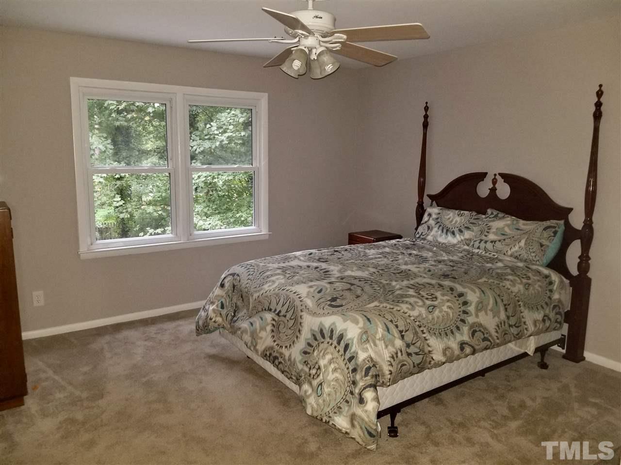 6420 Rockrest Court Raleigh, NC 27612 - Photo 8 of 22 Master bedroom overlooks backyard and has a ceiling fan