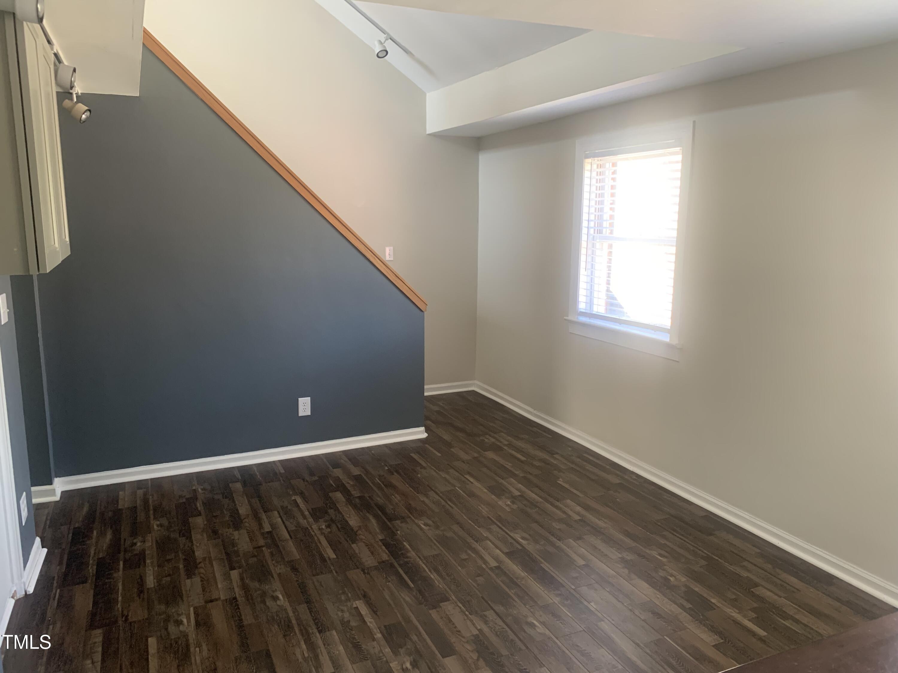 943 St Marys Street, Unit B Raleigh, NC 27605 - Photo 12 of 15 a view of an empty room with wooden floor and a window
