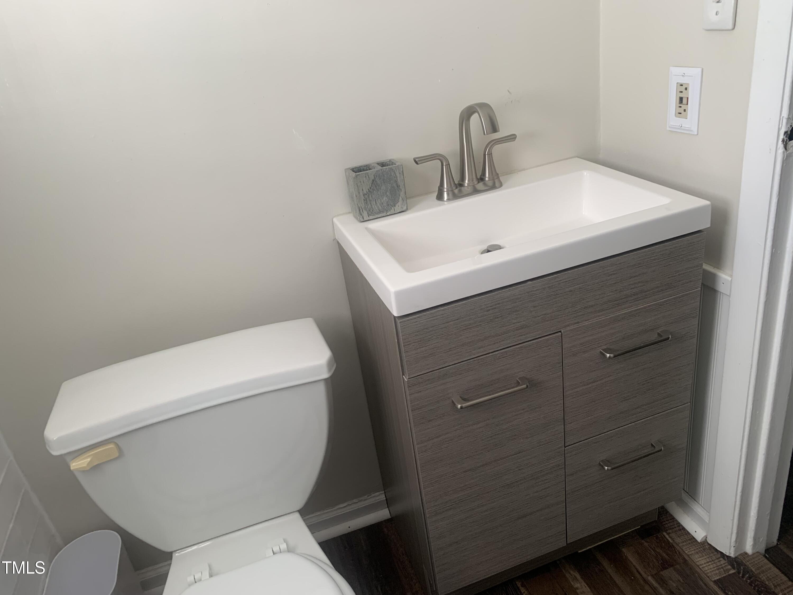 943 St Marys Street, Unit B Raleigh, NC 27605 - Photo 5 of 15 a white toilet sitting next to a bathroom sink