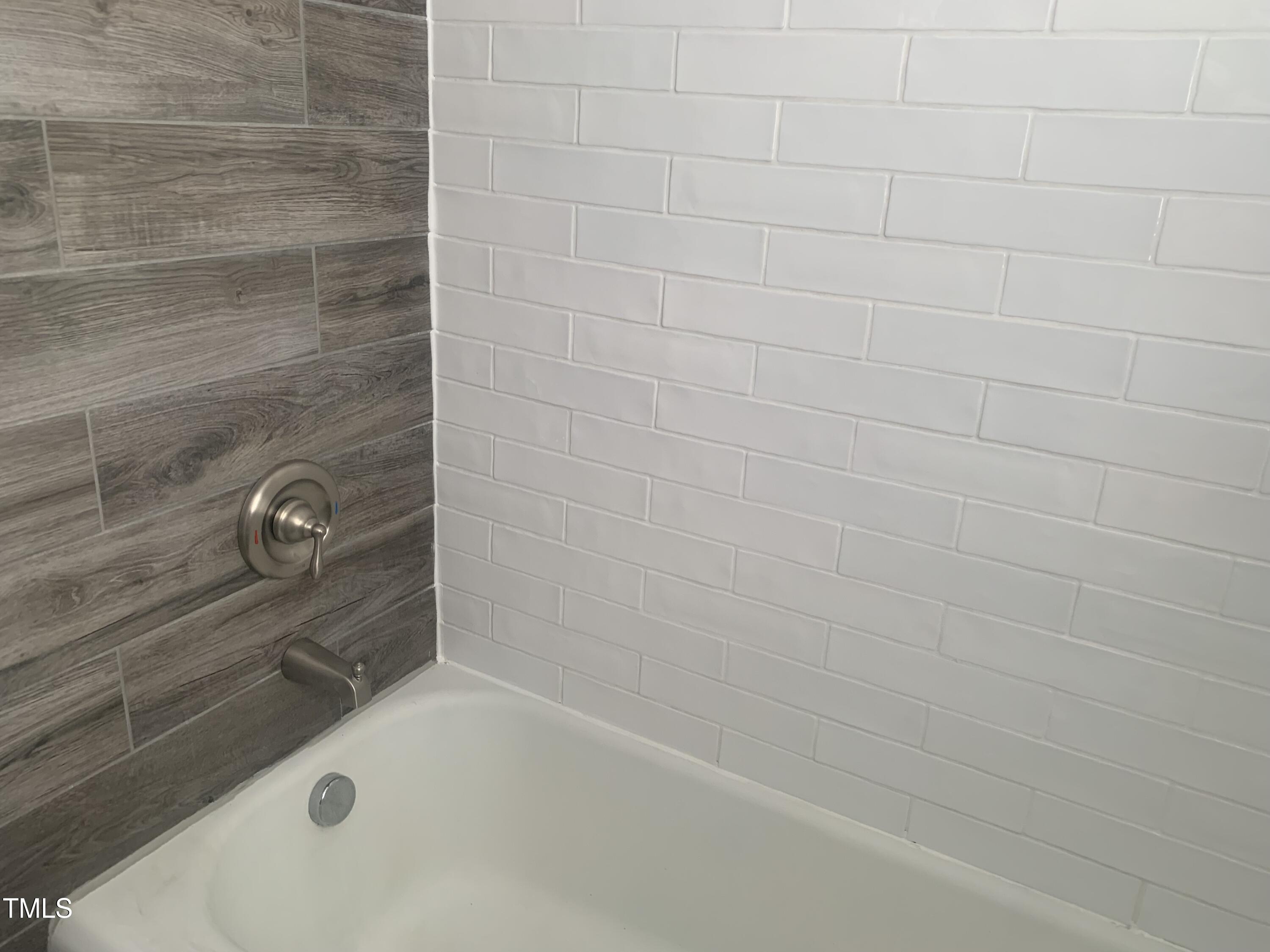 943 St Marys Street, Unit B Raleigh, NC 27605 - Photo 6 of 15 a bathroom with a bathtub