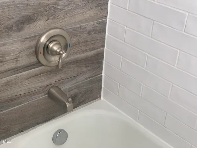 a large bed sitting in a bedroom next to a window