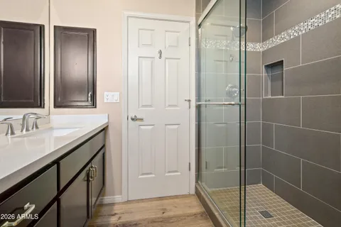 a bathroom with a granite countertop toilet sink and mirror