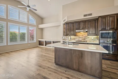 a view of kitchen with furniture and wooden floor