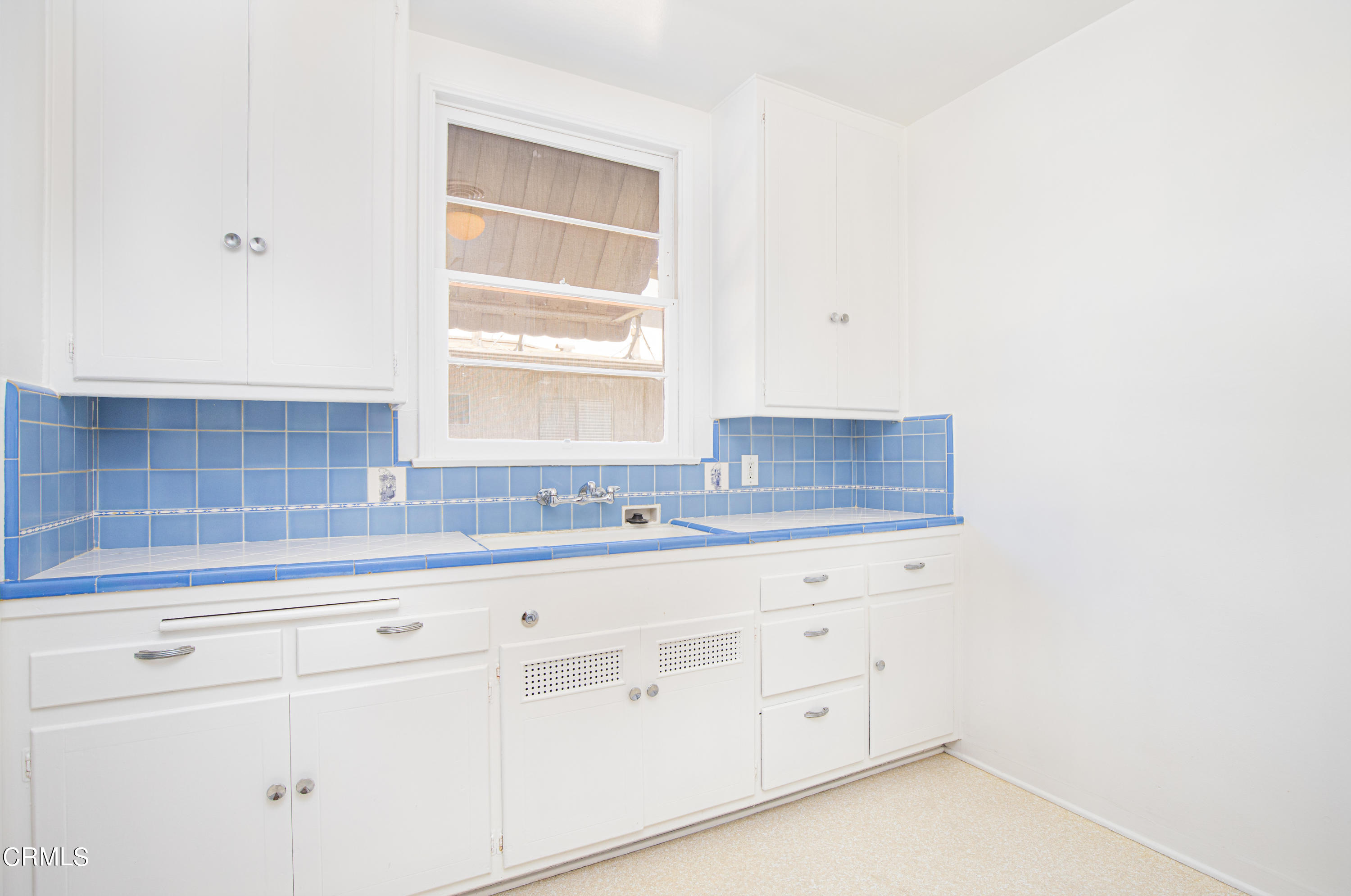 1564 Riverside Drive Glendale, CA 91201 - Photo 10 of 24 a kitchen with white cabinets and a window