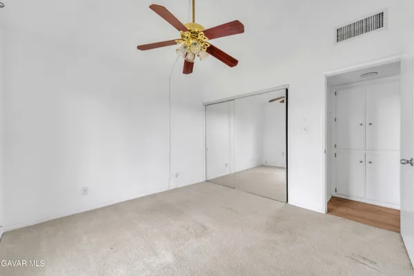 an empty room with windows and closet