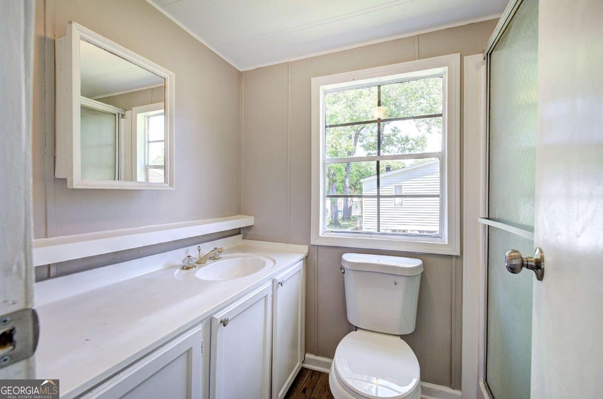 50 Tency Lane Northeast Rome, GA 30165 - Photo 11 of 23 a bathroom with a toilet sink and mirror