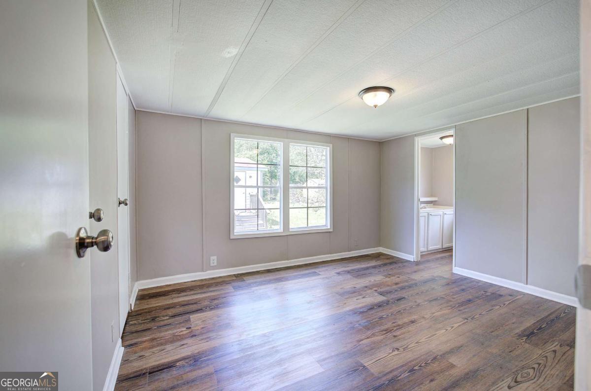 50 Tency Lane Northeast Rome, GA 30165 - Photo 14 of 23 wooden floor in an empty room with a window