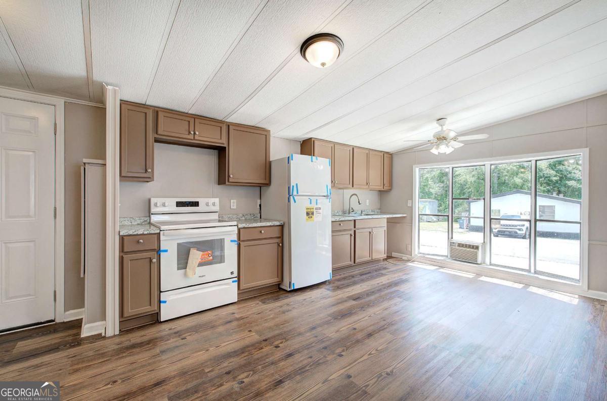 50 Tency Lane Northeast Rome, GA 30165 - Photo 20 of 23 a kitchen with white cabinets and white appliances