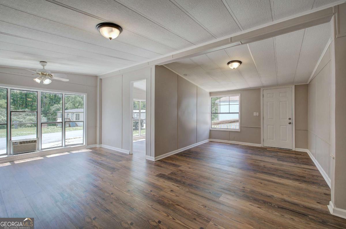50 Tency Lane Northeast Rome, GA 30165 - Photo 21 of 23 a view of an empty room with wooden floor and a window