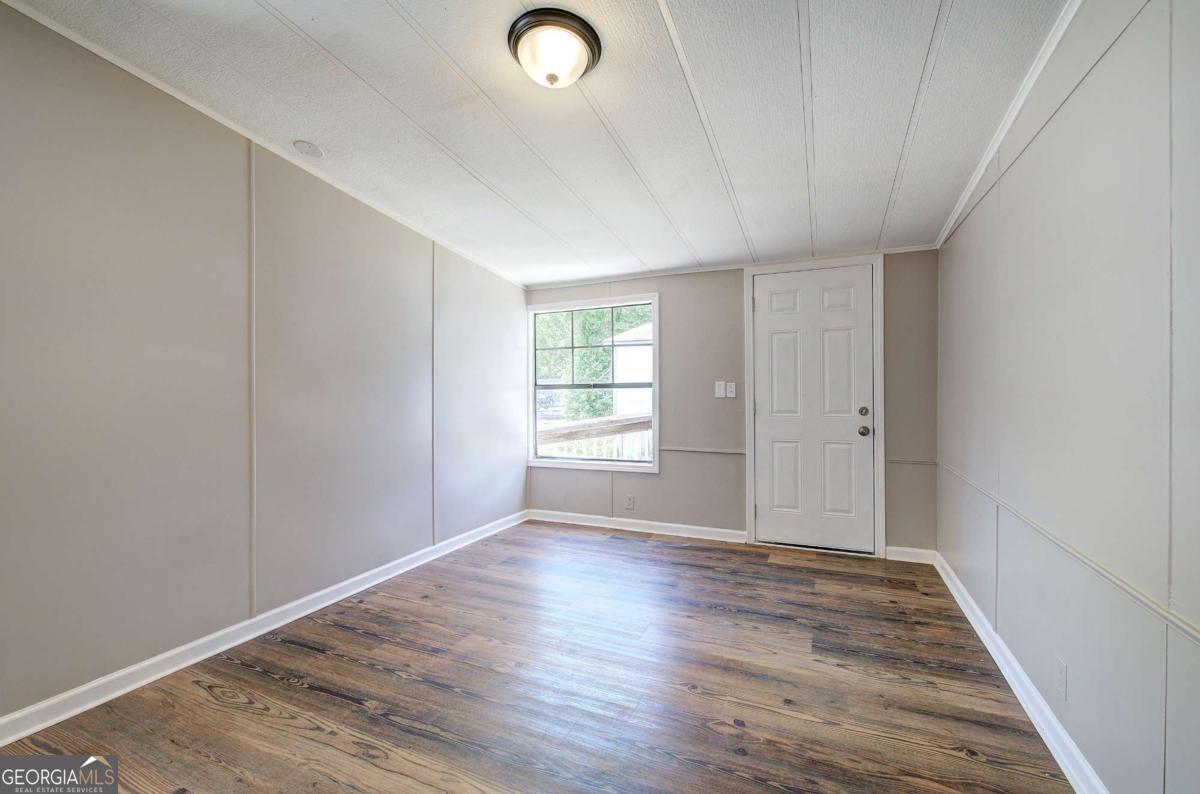 50 Tency Lane Northeast Rome, GA 30165 - Photo 22 of 23 an empty room with wooden floor and windows