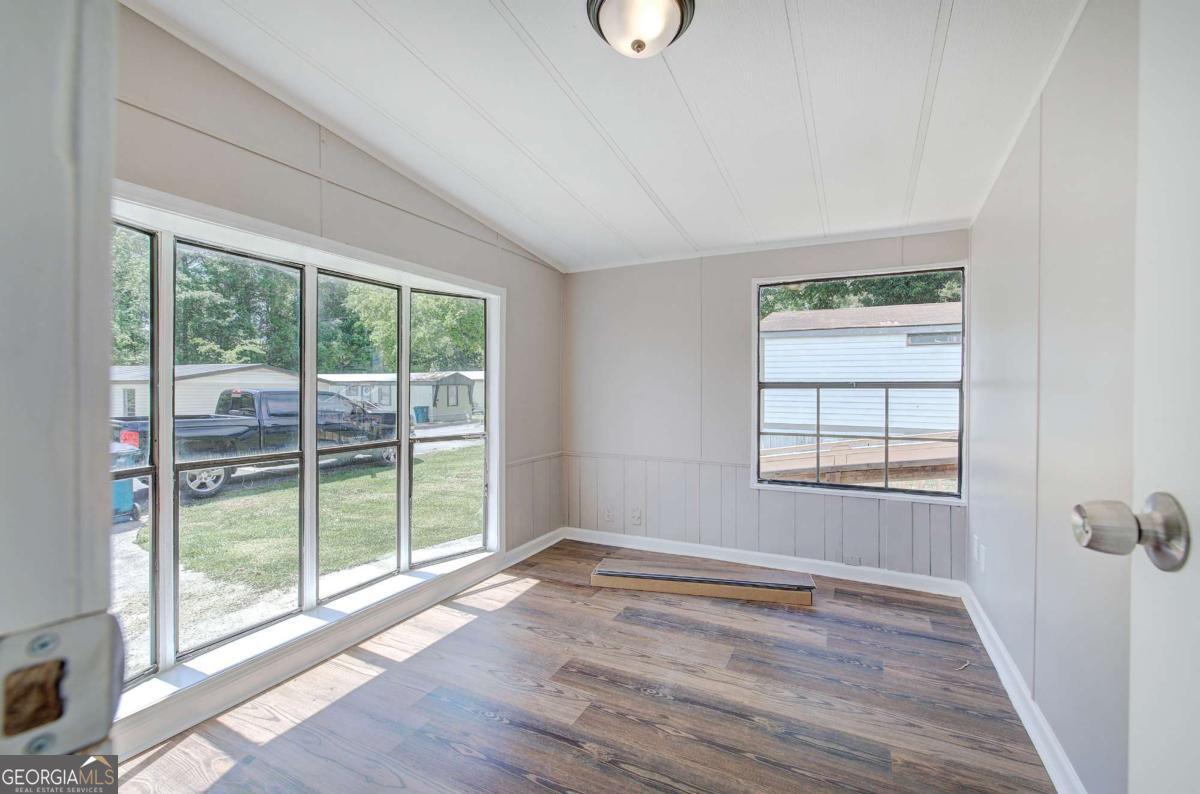 50 Tency Lane Northeast Rome, GA 30165 - Photo 6 of 23 an empty room with wooden floor and windows
