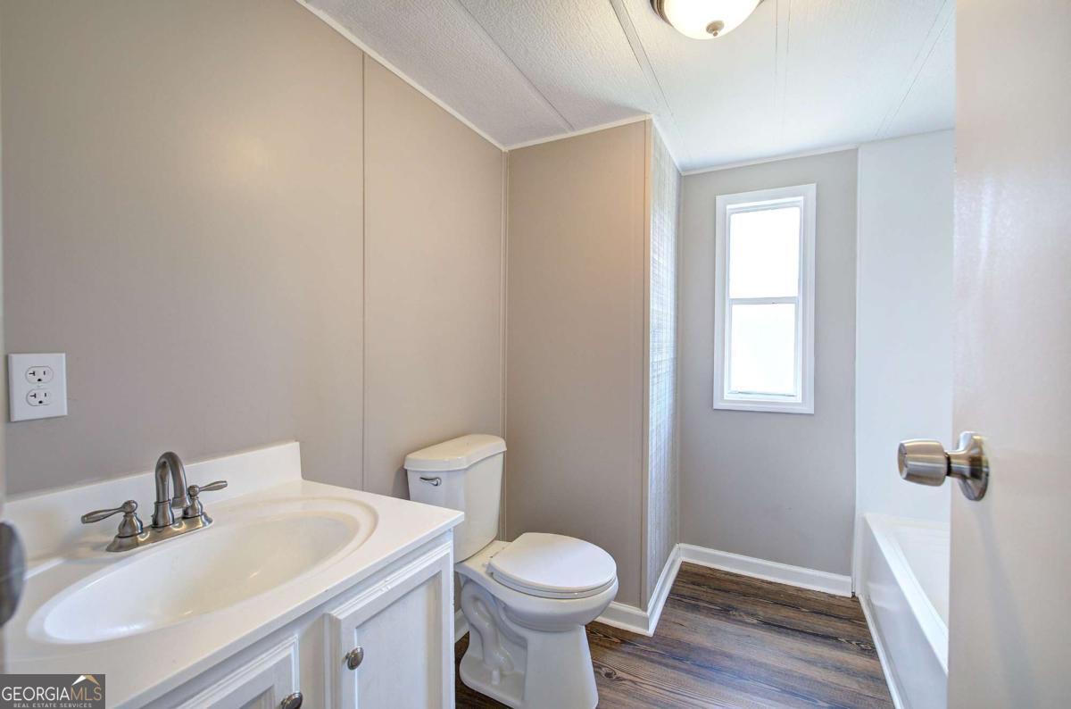 50 Tency Lane Northeast Rome, GA 30165 - Photo 8 of 23 a bathroom with a sink toilet and vanity