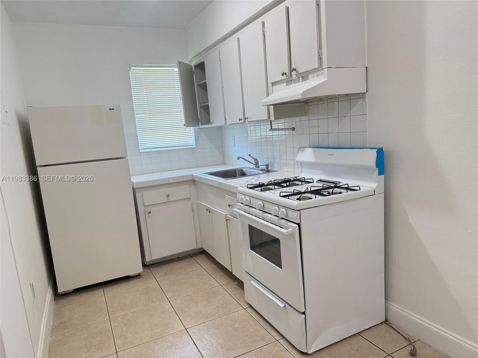 4300 Southwest 67th Avenue, Unit 38 Miami, FL 33155 - Photo 1 of 8 a white stove top oven sitting inside of a kitchen