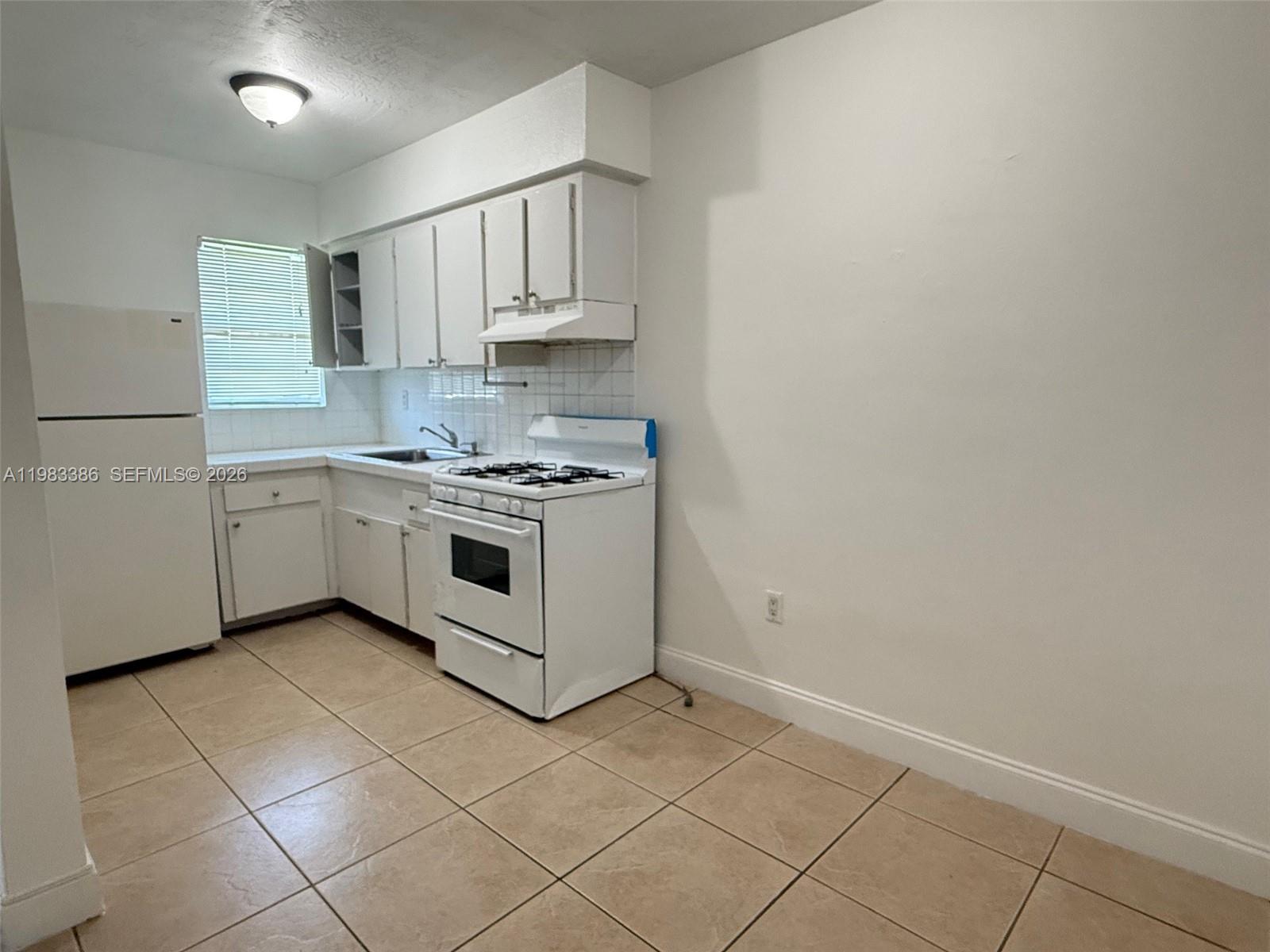 4300 Southwest 67th Avenue, Unit 38 Miami, FL 33155 - Photo 2 of 8 a kitchen with stainless steel appliances a sink and cabinets