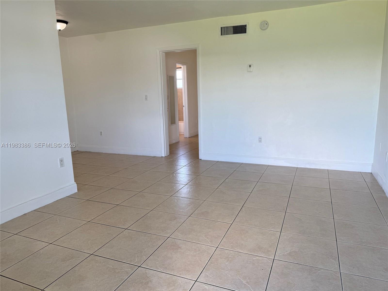 4300 Southwest 67th Avenue, Unit 38 Miami, FL 33155 - Photo 3 of 8 an empty room with white walls and tiles