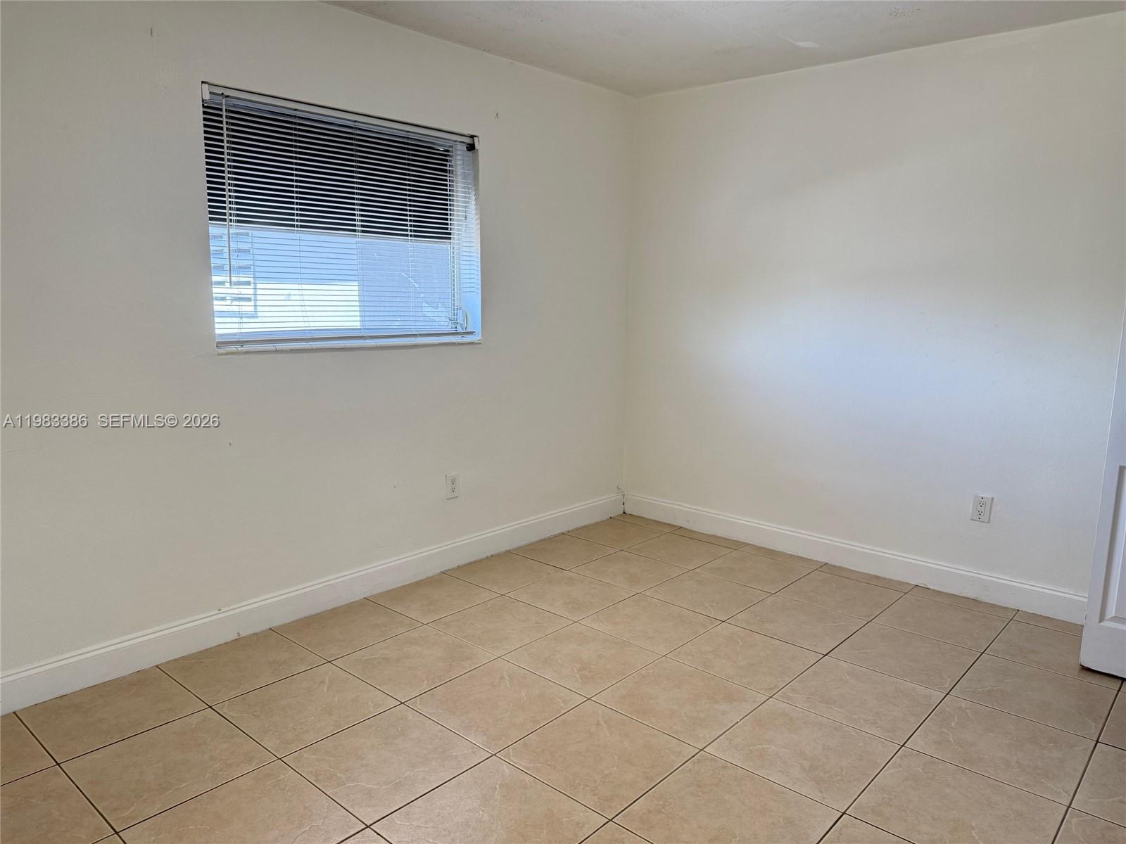 4300 Southwest 67th Avenue, Unit 38 Miami, FL 33155 - Photo 4 of 8 an empty room with a window