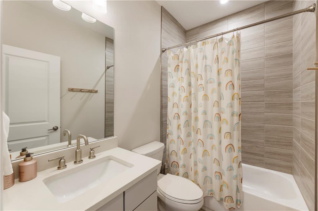 884 Mayfield Road Milton, GA 30004 - Photo 17 of 20 a bathroom with a sink a toilet and shower curtain