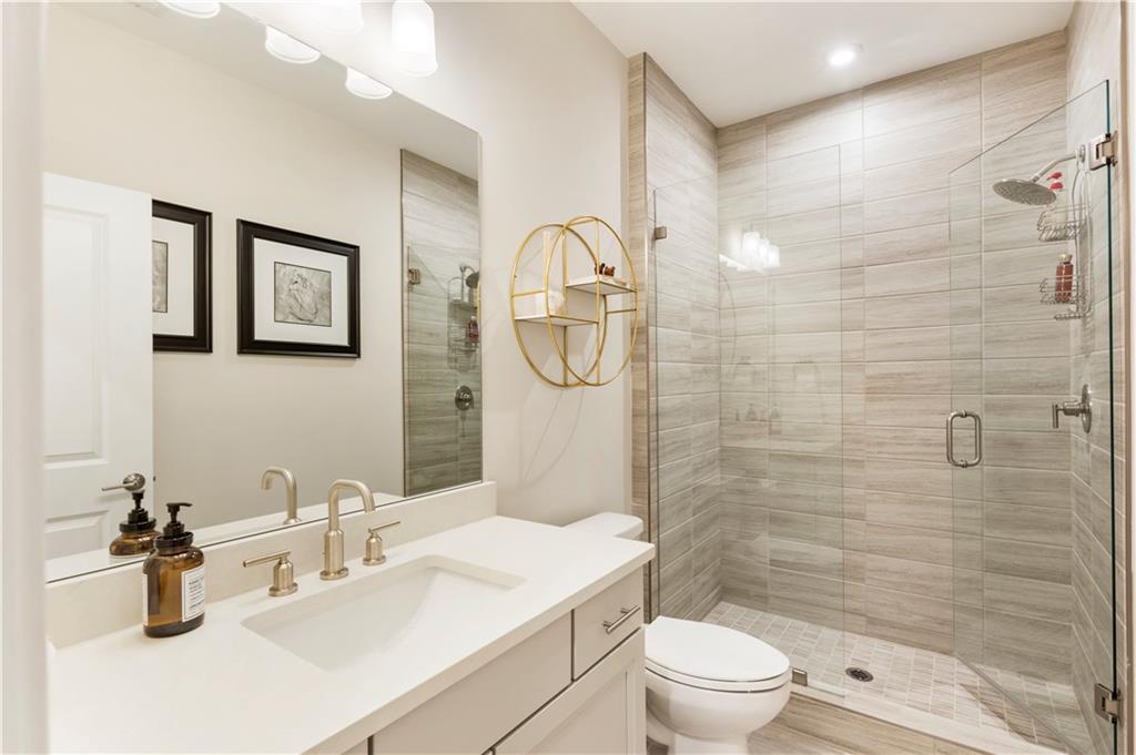 884 Mayfield Road Milton, GA 30004 - Photo 19 of 20 a bathroom with a sink a toilet and a mirror