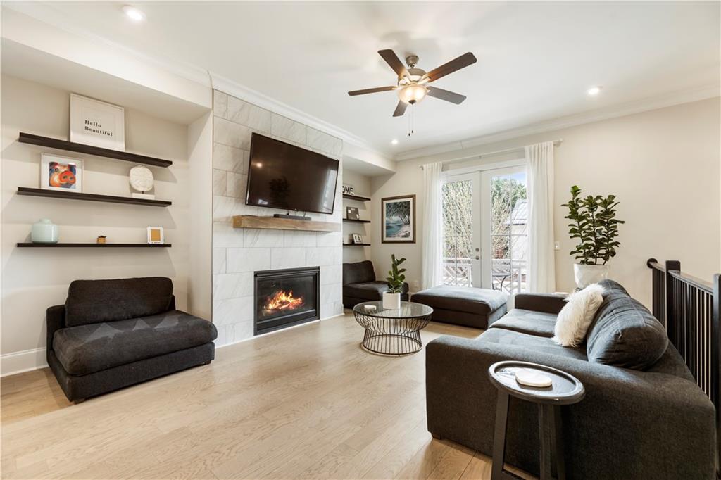 884 Mayfield Road Milton, GA 30004 - Photo 3 of 20 a living room with furniture a flat screen tv and a fireplace